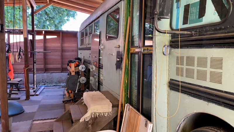 "Frankie" the bus, Hoang's 25-foot home next to a future home.