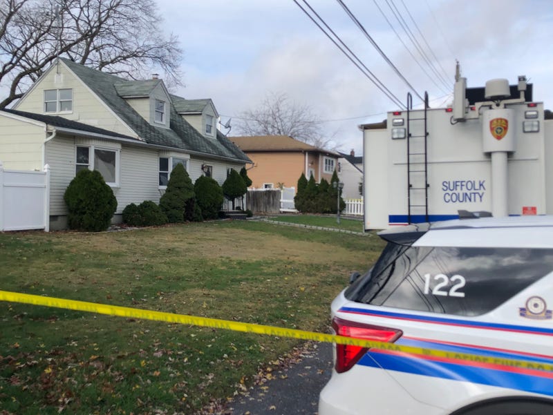 A 54-year-old woman was found dead inside a kitchen at this two-family home in Deer Park on Wednesday morning. Her 33-year-old son was "covered in blood" when he was arrested at the scene