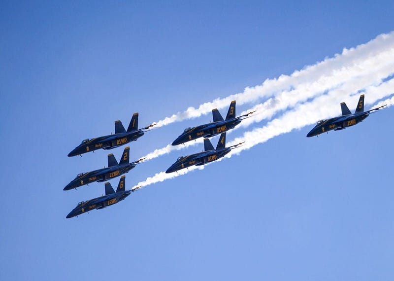 Six U.S. Navy Blue Angels fly in a triangle formation