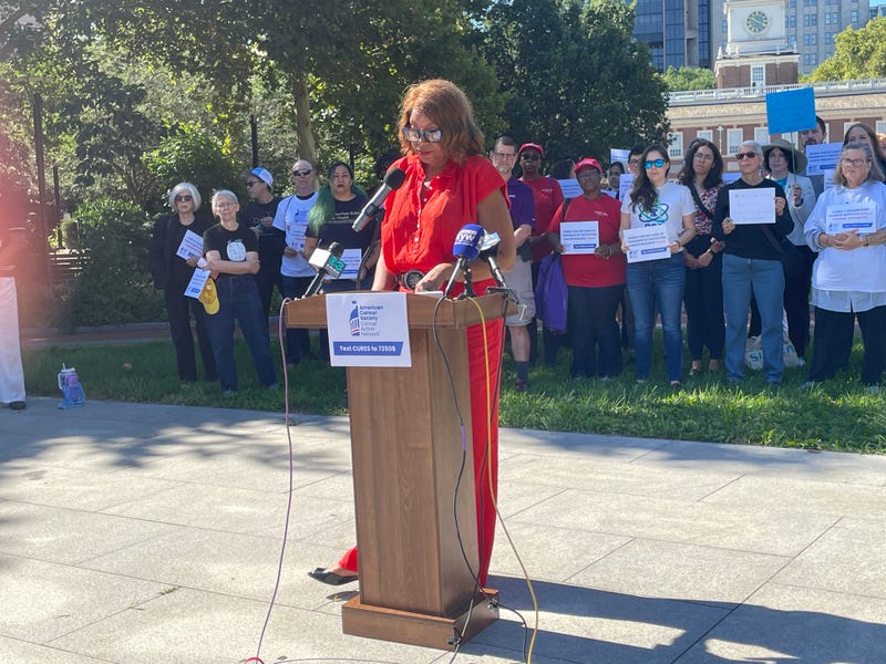 Cancer survivor Lynne Alston speaks at the rally for continued cancer research funding at Independence Mall on Tuesday, Aug. 26.