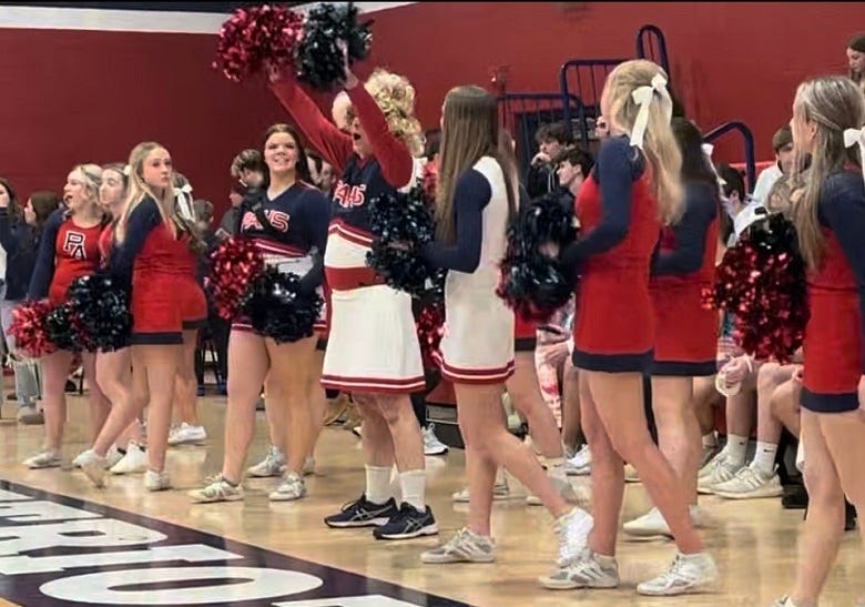Rocky cheering with Pittston Area squad