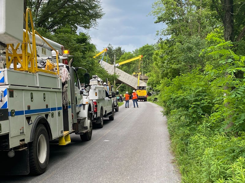 Crews attempt to remove the tractor trailer from Old Mill Road as it hangs off the 30 bypass.