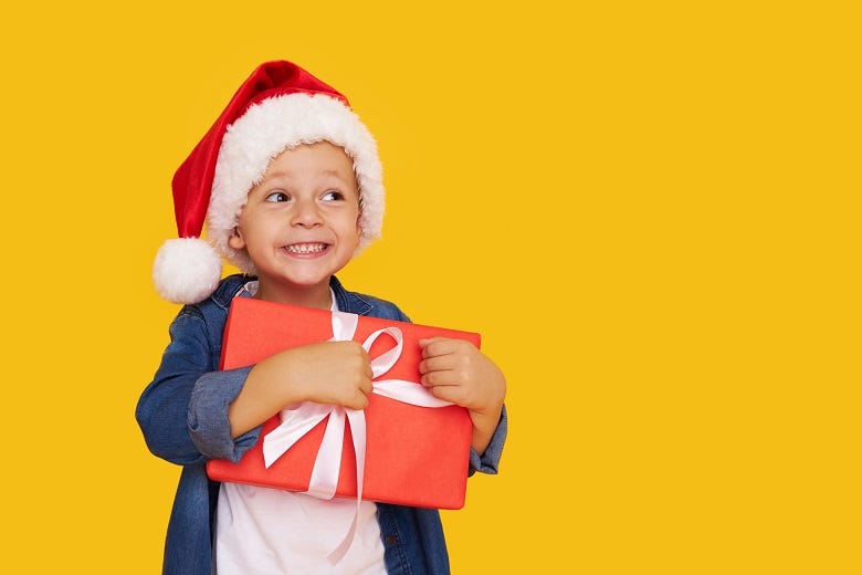 kid holding Christmas gift