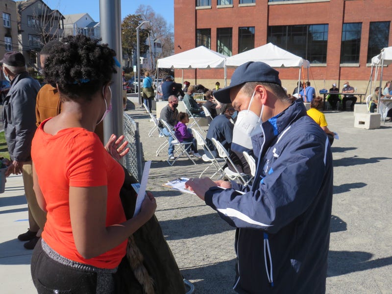 A Hartford Health Dept. employee registers a COVID-`19 vaccine recipient at a walk-up clinic in the Northeast neighborhood, 4/6/21.