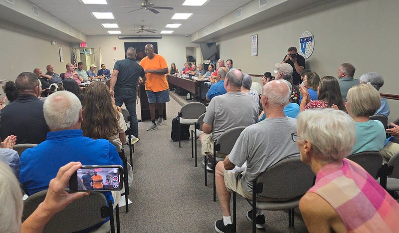 Nearly 70 people packed a Clinton County Board meeting Monday night to oppose a Proud Boys ad on a billboard near Central Community High School. 