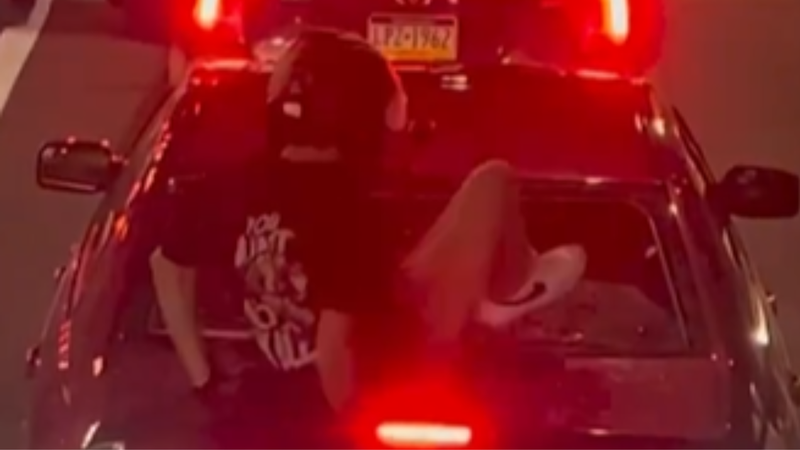 A still from the viral video that showed 26-year-old Cody Heron stomping out a woman's back window.