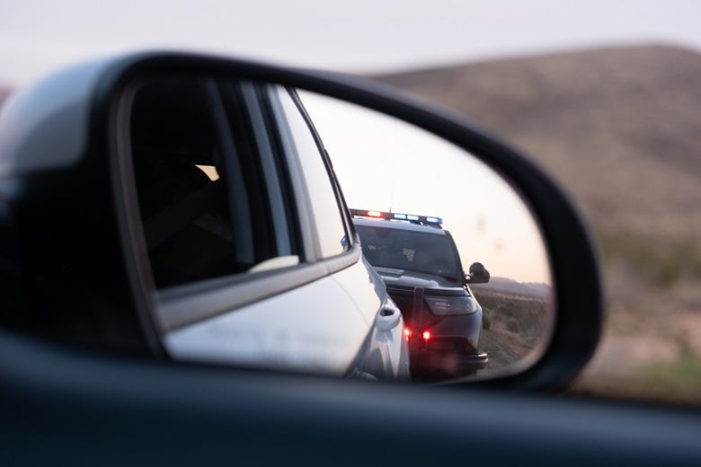 cop car in side mirror