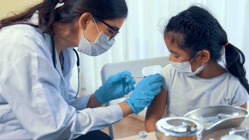 A young girl receives her COVID-19 vaccine