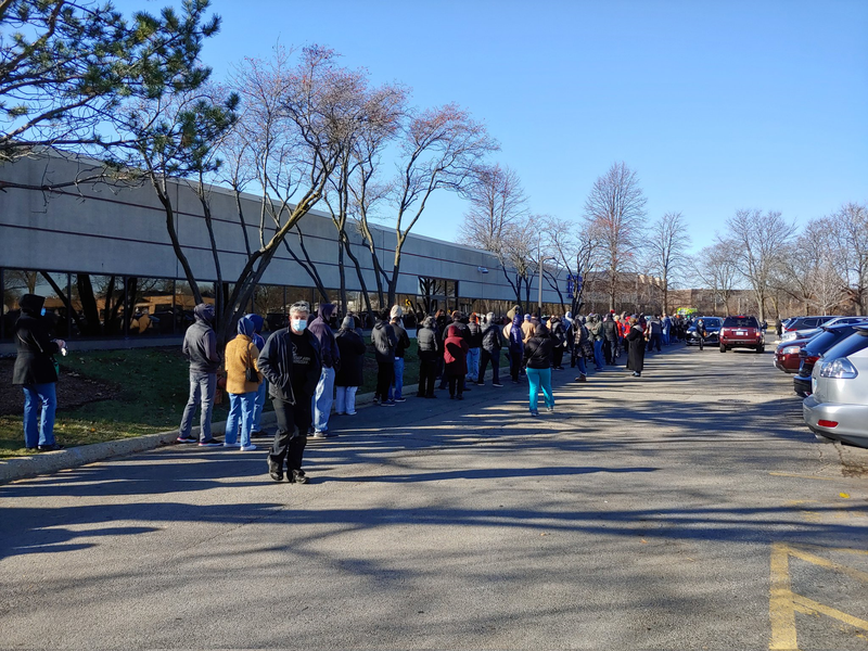 People line up for COVID-19 booster shot at mass vaccination site in Arlington Heights