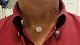 A COVID-19 sensor uses a small electronic device glued to the neck area where it can monitor the trachea for breathing.