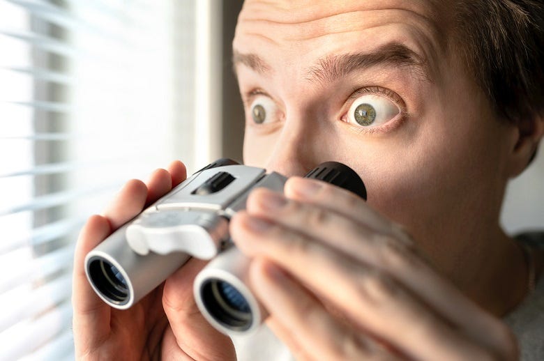 neighbor looking thru blinds with binoculars 