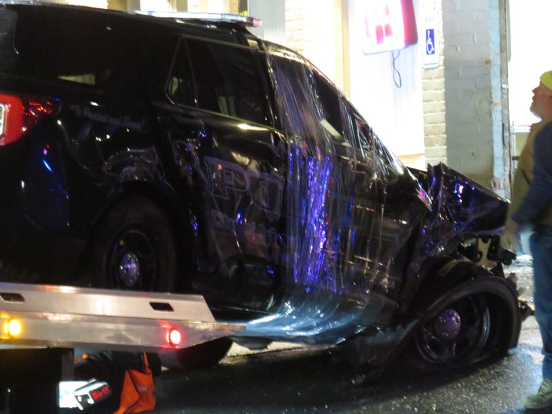 A badly damaged Bristol police SUV is towed from the entryway of Palma's Diner, 1/12/23