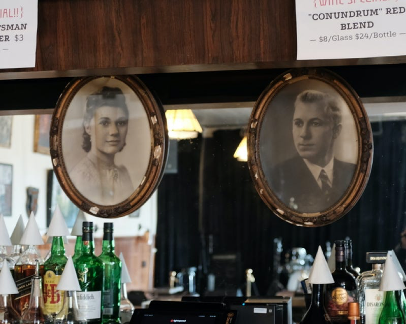 Portraits of former Cadieux Cafe owners Yvonne and Robert Devos hang above the bar