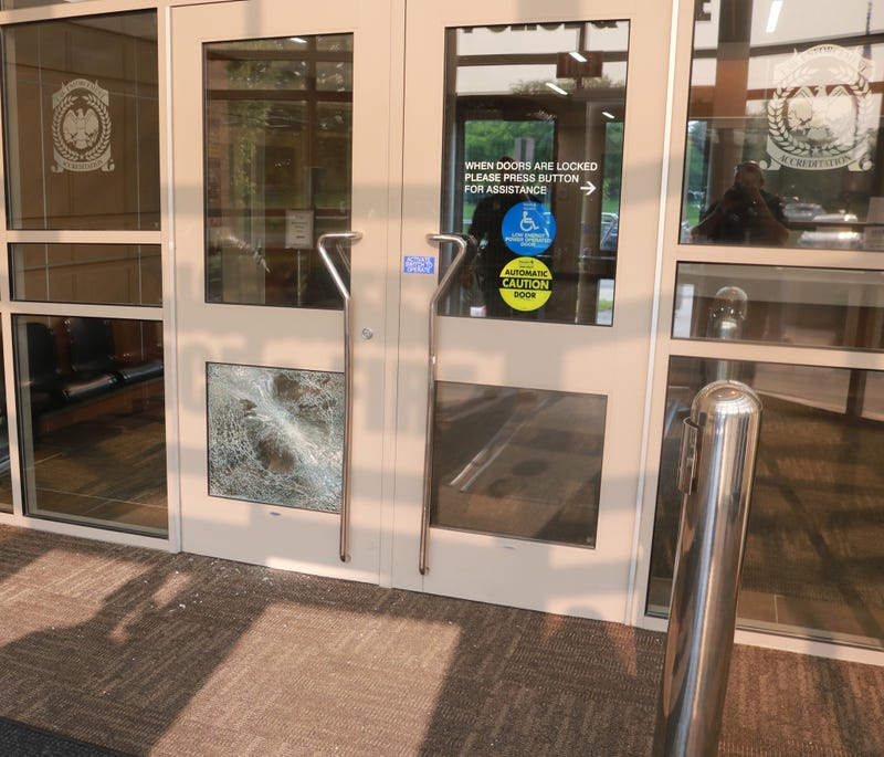 Glass is broken on the door of the Canton Police Department.