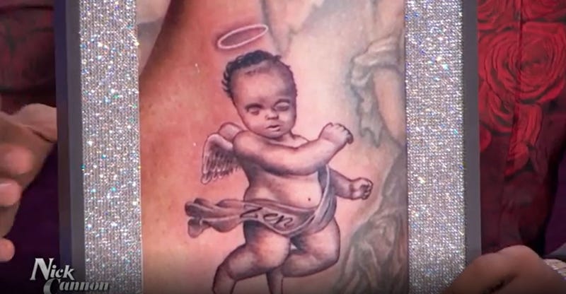 Nick Cannon shows a photo during the Dec. 10, 2021, episode of his show of a tattoo he received of his late son.