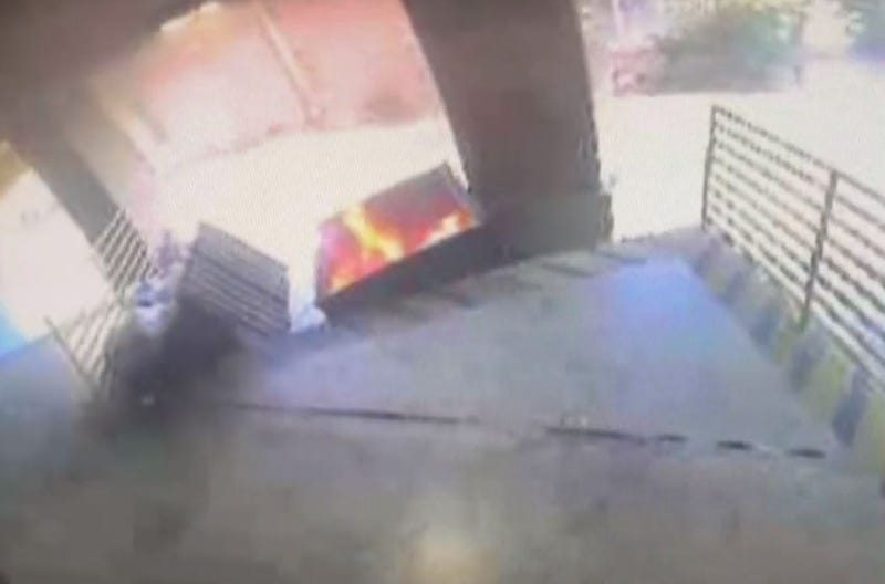 A fire in a dumpster behind the office of Texas Attorney General Ken Paxton on Wednesday, May 24, 2023.