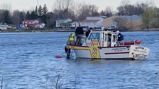 The boat was almost completely submerged when the firefighters arrived, officials said
