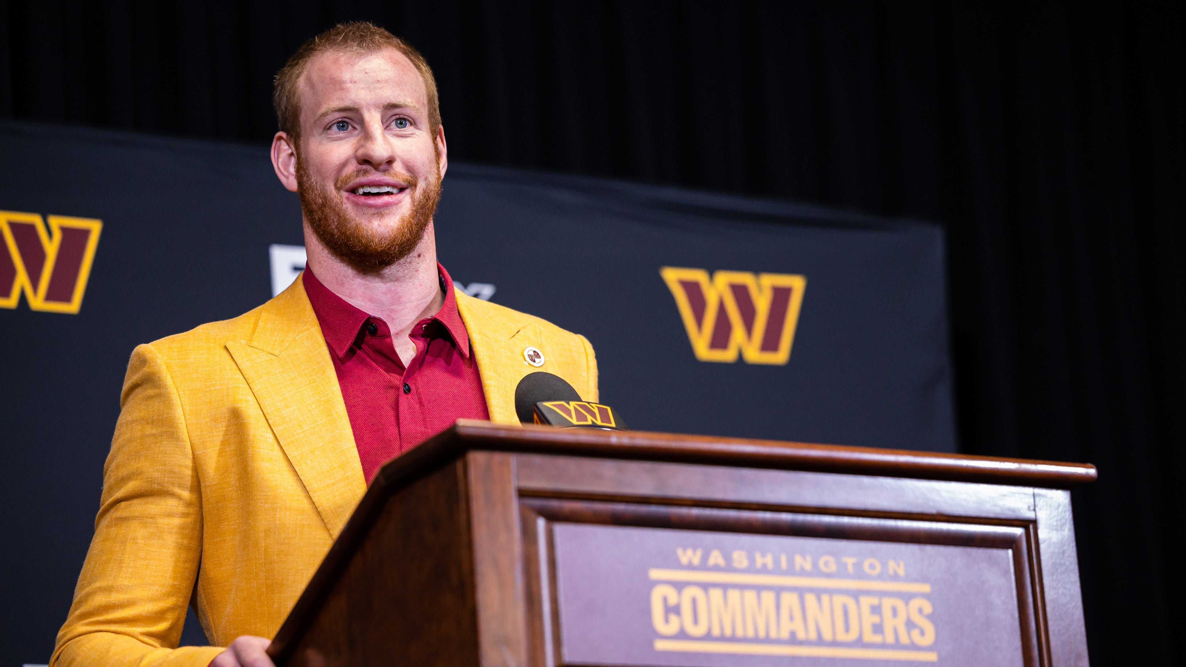 Carson Wentz roasted for mustard yellow and red suit at Commanders press conference