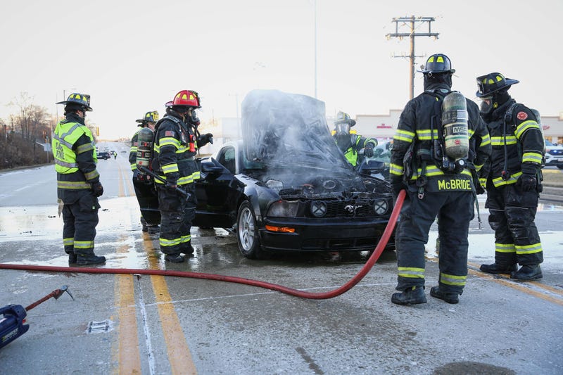 Firefighters putting out Mustang fire