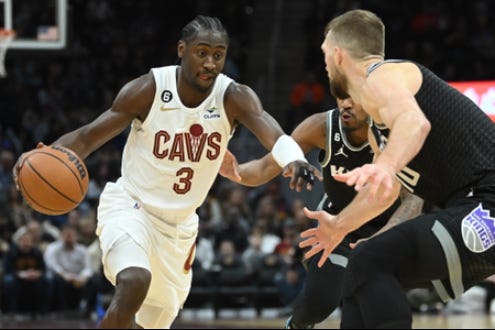 Cleveland Cavaliers guard Caris LeVert (3) drives to the basket against Sacramento Kings forward Domantas Sabonis (10) and guard Malik Monk (0) during the second half at Rocket Mortgage FieldHouse.