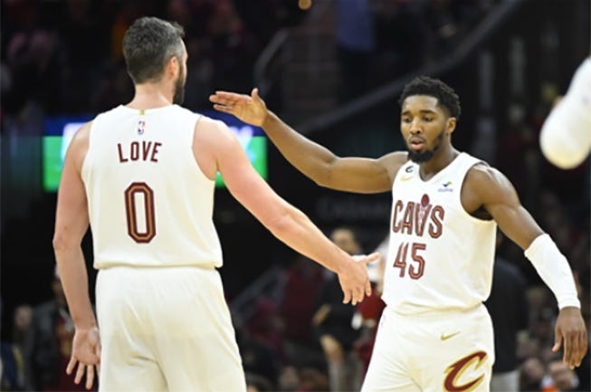 Cleveland Cavaliers forward Kevin Love (0) and guard Donovan Mitchell (45) celebrate in the fourth quarter against the New York Knicks at Rocket Mortgage FieldHouse.