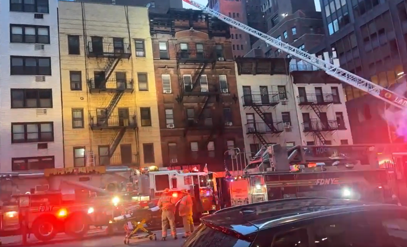 Fire officials respond to a blaze at a five-story apartment building in Murray Hill, Manhattan on Sunday morning that killed one man.