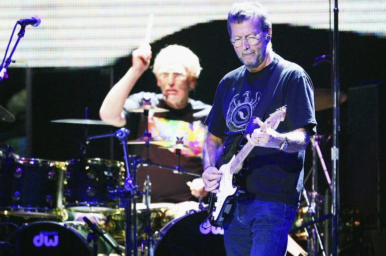 Eric Clapton (R) and Ginger Baker of Cream perform onstage at Madison Sqaure Garden October 25, 2005