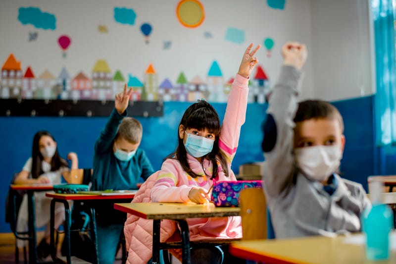 Masked student answer a teacher's question