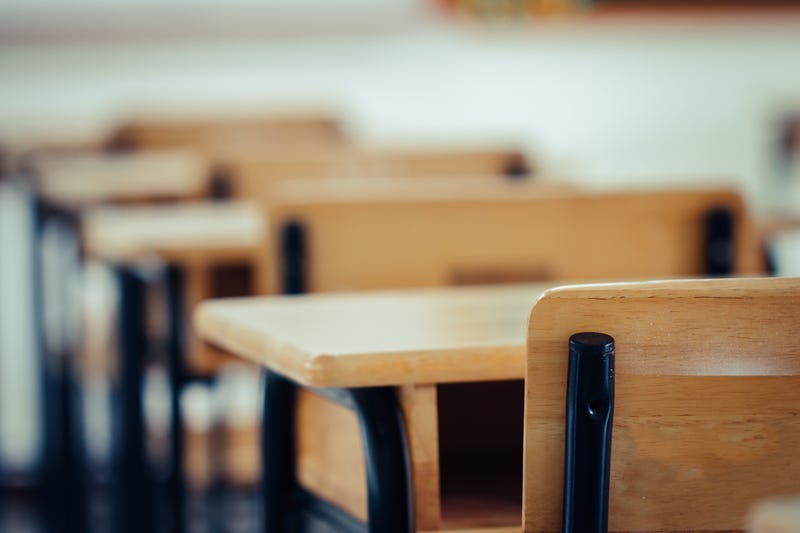 A row of empty desks in a classroom 
