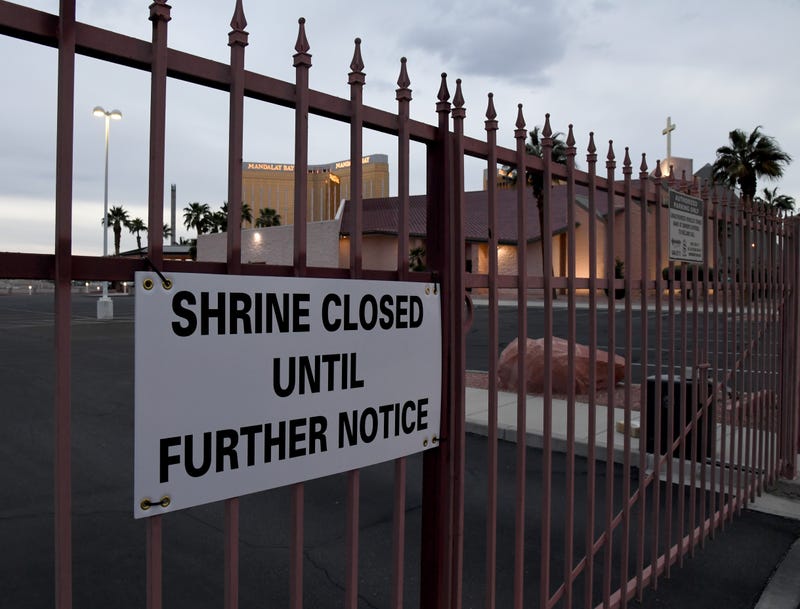 he shuttered Mandalay Bay Resort and Casino is seen through a fence with a closed sign posted at the Shrine of the Most Holy Redeemer Roman Catholic church as a result of the statewide shutdown due to the continuing spread of the coronavirus across the United States on March 28, 2020 in Las Vegas, Nevada.