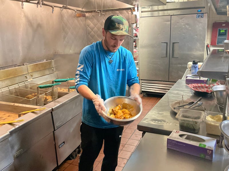 Chef preparing wings at Anchor Bar on Maple Rd. in Amherst