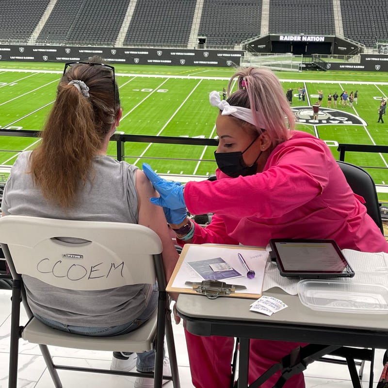 A woman receives her coronavirus vaccination at Allegiant Stadium