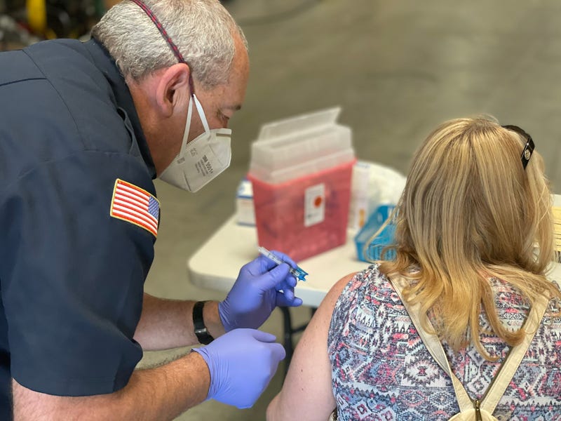 A woman receives her coronavirus vaccination