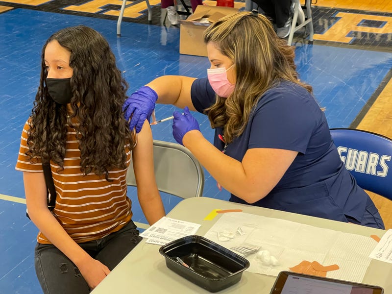 A young girl gets her coronavirus vaccination