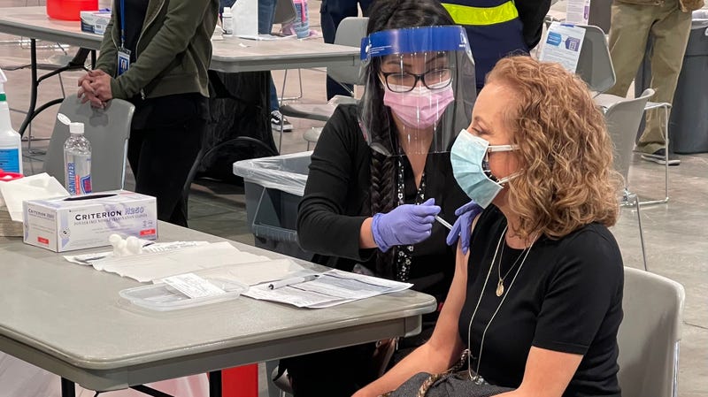 A woman receives her coronavirus vaccination