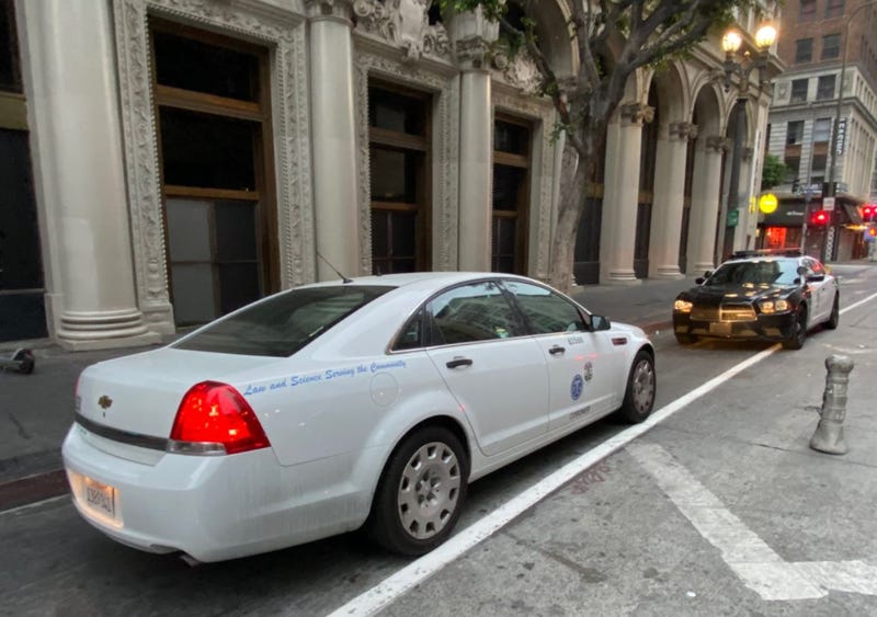 L.A. County corner car outside apartment where three men were found dead Thursday morning.