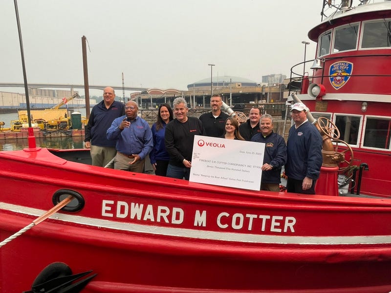 Crew of Buffalo Fireboat Edward M. Cotter accepts generous donation from Veolia Company.