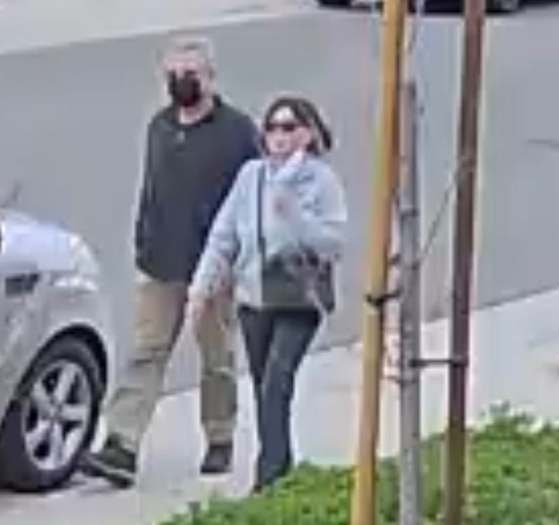 couple walking toward open house