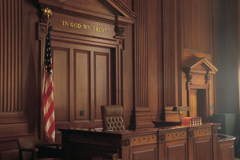 A view of the judge's bench from an empty jury box.