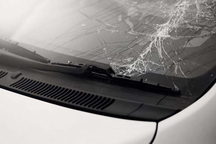 Cracked windshield on a silver vehicle