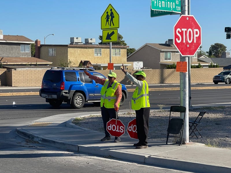 School crossing guards work a busy intersection