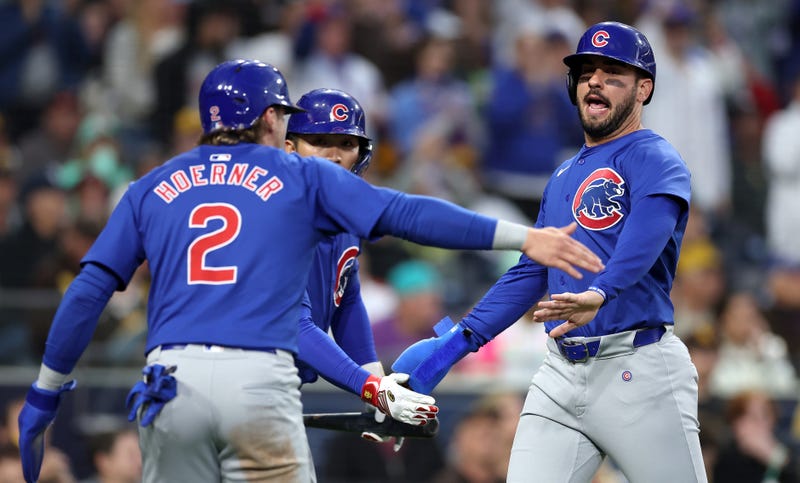 Cubs second baseman Nico Hoerner (2) and outfielder Mike Tauchman (right) celebrate.