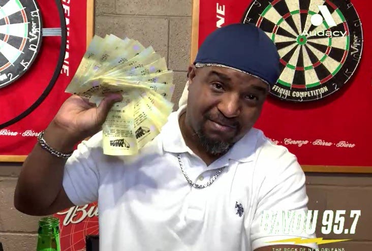 Coleman holding a handful of Mega Millions lottery tickets