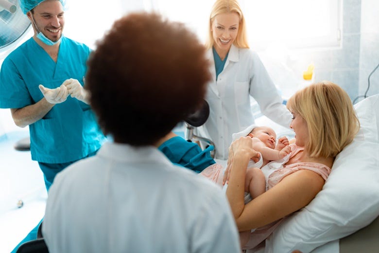 new Mom and doctors in delivery room