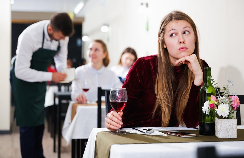 woman alone at a restaurant table