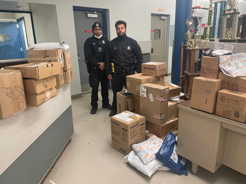 Officers Corey Davis and Malcolm Jackson with the 41 stolen packages