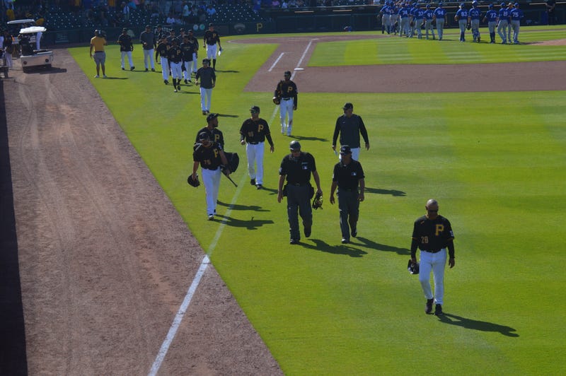 players & umps walking off field in Bradenton