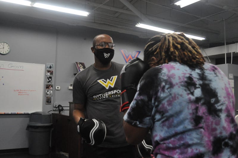 Tim Witherspoon Jr. trains a gym member.