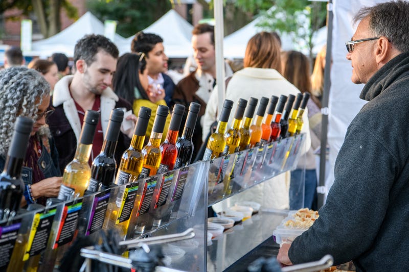 Man, woman visit booth booth at Lincoln Park Wine Fest