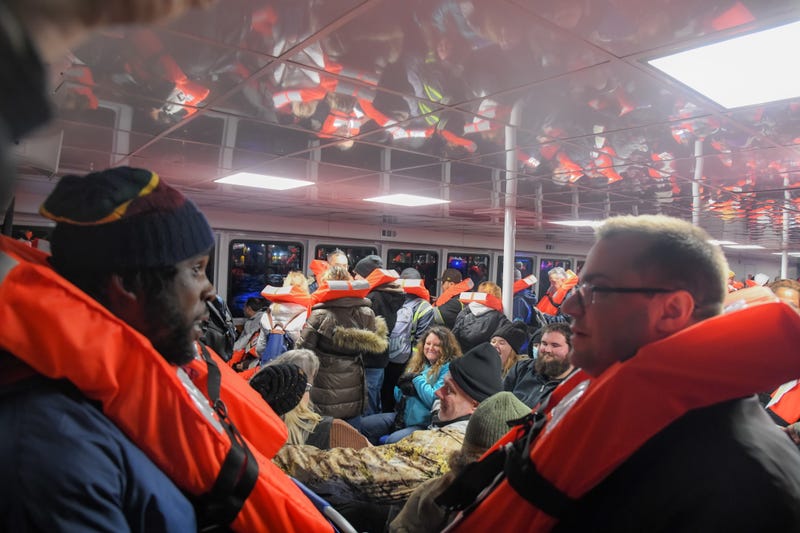 Passengers donned life jackets while they waited to be taken off the vessel